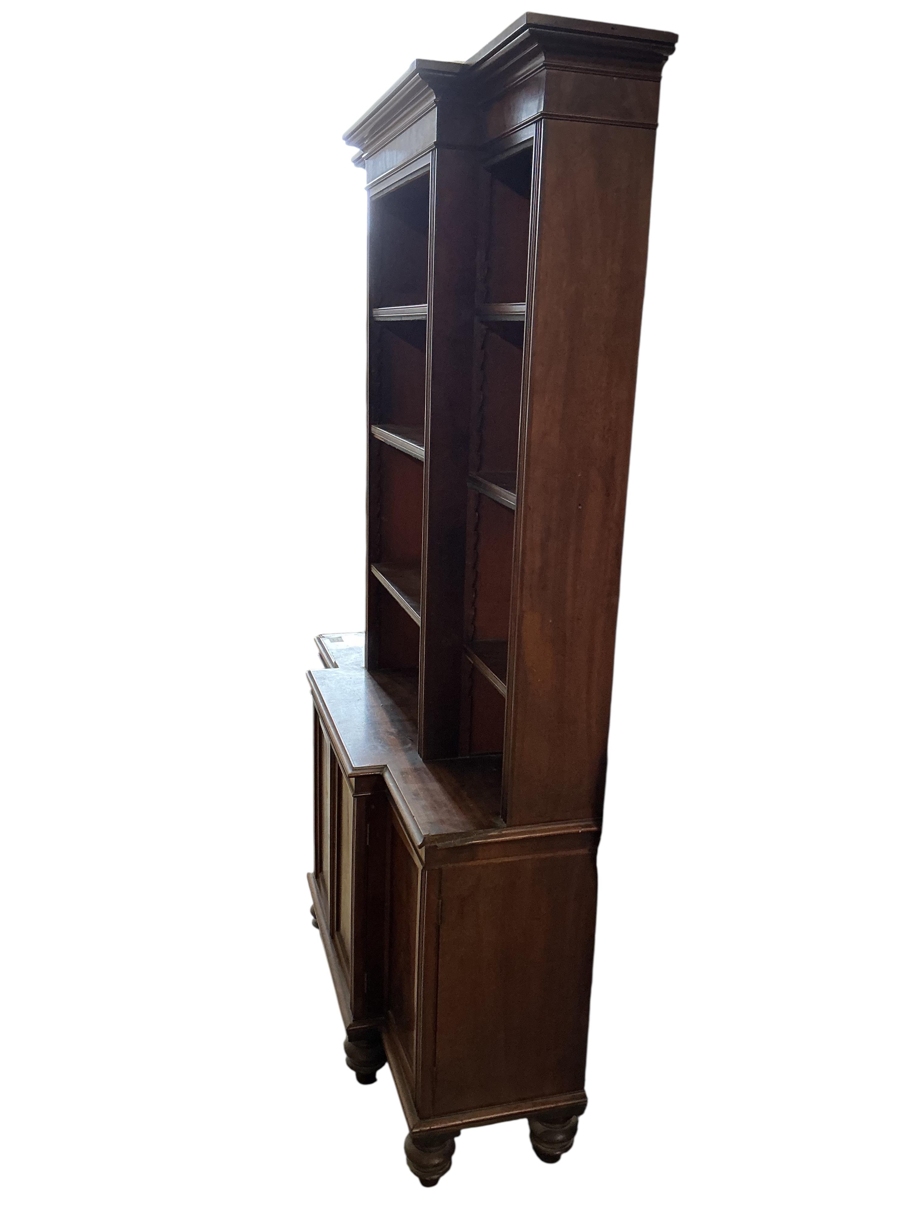 A small George IV style mahogany breakfront bookcase / cupboard, width 110cm, depth 30cm, height 172cm